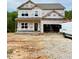 Two-story home under construction featuring a spacious two-car garage and ample windows for natural light at 50 Moonraker Dr, Spring Hope, NC 27882