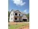New construction home with builder's wrap, showcasing its framing and potential at 50 Moonraker Dr, Spring Hope, NC 27882