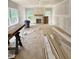 Unfinished living room with fireplace, bright windows, and material ready for installation at 50 Moonraker Dr, Spring Hope, NC 27882