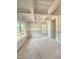 Unfinished living room boasts coffered ceilings, wainscoting, and bright natural light from the windows at 50 Moonraker Dr, Spring Hope, NC 27882