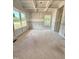 Unfinished living room boasts coffered ceilings, wainscoting, and bright natural light from the windows at 50 Moonraker Dr, Spring Hope, NC 27882