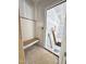 Unfinished mud room featuring shiplap wall, storage bench, and doorway to additional rooms at 50 Moonraker Dr, Spring Hope, NC 27882