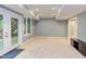 Finished basement area with a walkout to the yard and neutral carpet at 5314 Taproot Ln, Durham, NC 27705