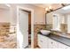 Well-lit bathroom featuring modern fixtures and a white vessel sink on a black countertop at 5314 Taproot Ln, Durham, NC 27705