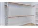 Spacious walk-in closet with built-in shelving and wooden rods for ample storage at 5314 Taproot Ln, Durham, NC 27705
