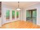 Dining room with hardwood floors leading to a sunroom and backyard deck at 5314 Taproot Ln, Durham, NC 27705