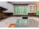 Bright kitchen features granite counters and stainless dishwasher next to breakfast bar at 5314 Taproot Ln, Durham, NC 27705