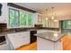 Well-lit kitchen with granite countertops and stainless steel appliances and bar at 5314 Taproot Ln, Durham, NC 27705
