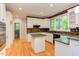 Well lit kitchen featuring white cabinets and modern stainless appliances at 5314 Taproot Ln, Durham, NC 27705
