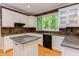 Spacious kitchen with white cabinets, stone backsplash, and granite countertops at 5314 Taproot Ln, Durham, NC 27705