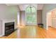 Spacious living room showcasing hardwood floors, fireplace, vaulted ceiling, ceiling fan and large windows with natural light at 5314 Taproot Ln, Durham, NC 27705