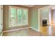 Charming sunroom adjacent to fireplace with multiple windows and natural light at 5314 Taproot Ln, Durham, NC 27705