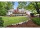 Expansive backyard with a deck, patio and lush green lawn at 5513 Doemont Dr, Apex, NC 27539