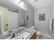 Well-lit bathroom featuring granite countertop, framed mirror, and soft gray walls at 5513 Doemont Dr, Apex, NC 27539