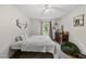 Cozy bedroom with hardwood floors, ceiling fan, and a dresser with decorative accents at 5513 Doemont Dr, Apex, NC 27539