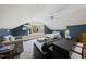 Bedroom featuring wood-look floors, blue accent wall, large window, and vaulted ceiling at 5513 Doemont Dr, Apex, NC 27539