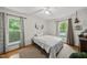 Bright bedroom with hardwood floors, ceiling fan, and natural light from two windows at 5513 Doemont Dr, Apex, NC 27539