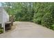 Exterior with a long concrete driveway, greenery, and a glimpse of the home's backyard at 5513 Doemont Dr, Apex, NC 27539