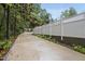 Driveway lined with a white picket fence and beautiful, mature trees at 5513 Doemont Dr, Apex, NC 27539