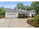 Charming home boasts a well-manicured lawn, attached two-car garage, and inviting curb appeal at 5513 Doemont Dr, Apex, NC 27539