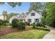 Beautiful home features bright blue shutters, mature landscaping, and a classic design at 5513 Doemont Dr, Apex, NC 27539
