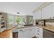 Kitchen features white cabinets, granite countertops, stainless steel appliances and an eat-in breakfast nook at 5513 Doemont Dr, Apex, NC 27539