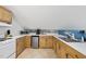 Functional kitchenette with white countertops, wood cabinets, and modern appliances in a cozy space at 5513 Doemont Dr, Apex, NC 27539