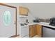 Compact kitchenette featuring a white stove, microwave, and mini-fridge, nestled within a well-lit area at 5513 Doemont Dr, Apex, NC 27539