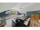 Bright and airy living space with a TV, bar seating, and a large window seat in a modern design at 5513 Doemont Dr, Apex, NC 27539