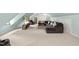 Spacious living room with neutral carpeting, sectional sofa, and a mounted television at 5513 Doemont Dr, Apex, NC 27539