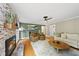 Inviting living room with brick fireplace, hardwood floors, and comfortable seating arrangement at 5513 Doemont Dr, Apex, NC 27539