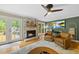 Cozy living area with fireplace, doors to deck, and entertainment center with mounted television at 5513 Doemont Dr, Apex, NC 27539