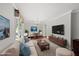 Inviting living room that features fireplace, large windows, neutral colors, and hardwood floors at 5513 Doemont Dr, Apex, NC 27539
