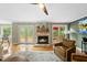 Spacious living room featuring fireplace, hardwood floors, and natural light from the backyard at 5513 Doemont Dr, Apex, NC 27539