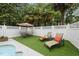 Relaxing pool area with lounge chairs and a table with umbrella at 5513 Doemont Dr, Apex, NC 27539
