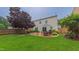 Spacious backyard featuring patio with outdoor dining area, fenced yard and mature trees at 5535 Spindlewood Ct, Durham, NC 27703