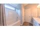 Bathroom showcasing a shower and tub combination, and a marble sink at 5535 Spindlewood Ct, Durham, NC 27703