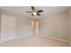 Neutral bedroom featuring carpet, ceiling fan and two doors at 5535 Spindlewood Ct, Durham, NC 27703