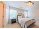Comfortable bedroom with carpet flooring, a ceiling fan, and natural light from the windows at 5535 Spindlewood Ct, Durham, NC 27703