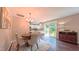 Open dining area features a chandelier, wood floors, and a door leading to the backyard at 5535 Spindlewood Ct, Durham, NC 27703