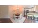 A dining room with chandelier and adjoined by a kitchen and an abstract painting at 5535 Spindlewood Ct, Durham, NC 27703