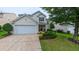 Charming two-story home with well-manicured lawn, stone accents, and a two-car garage at 5535 Spindlewood Ct, Durham, NC 27703