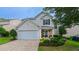 Charming home featuring well-manicured lawn, stone accents and a two-car garage at 5535 Spindlewood Ct, Durham, NC 27703