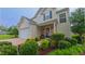 Lovely home featuring a well-manicured lawn, a quaint front porch, and a spacious two-car garage at 5535 Spindlewood Ct, Durham, NC 27703