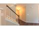 Hallway with a stairway leading to the upper level and dark hardwood floors at 5535 Spindlewood Ct, Durham, NC 27703