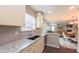 Bright and airy kitchen featuring granite countertops and open floor plan to the living area at 5535 Spindlewood Ct, Durham, NC 27703