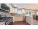 Modern kitchen with stainless steel appliances, granite countertops, and backyard view at 5535 Spindlewood Ct, Durham, NC 27703