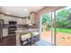 Well-lit kitchen featuring stainless steel appliances and a view of the backyard through sliding glass doors at 5535 Spindlewood Ct, Durham, NC 27703