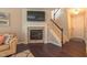 Inviting living room featuring a fireplace, a TV, and stairs to the upper level at 5535 Spindlewood Ct, Durham, NC 27703