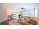 Bright living room with hardwood floors, ceiling fan, open to dining and kitchen at 5535 Spindlewood Ct, Durham, NC 27703